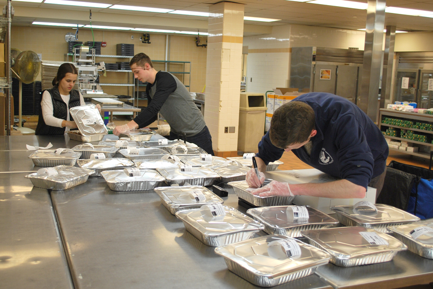 Volunteers help to prepare meals