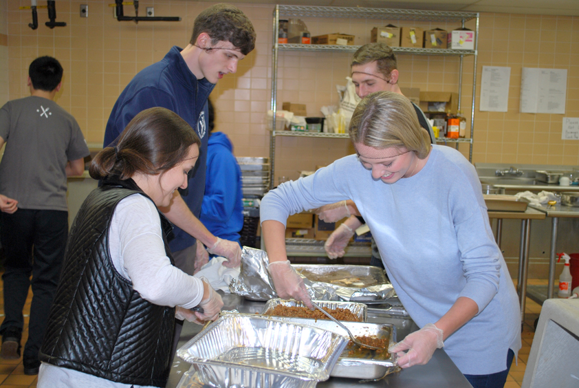 Volunteers gathering leftover food